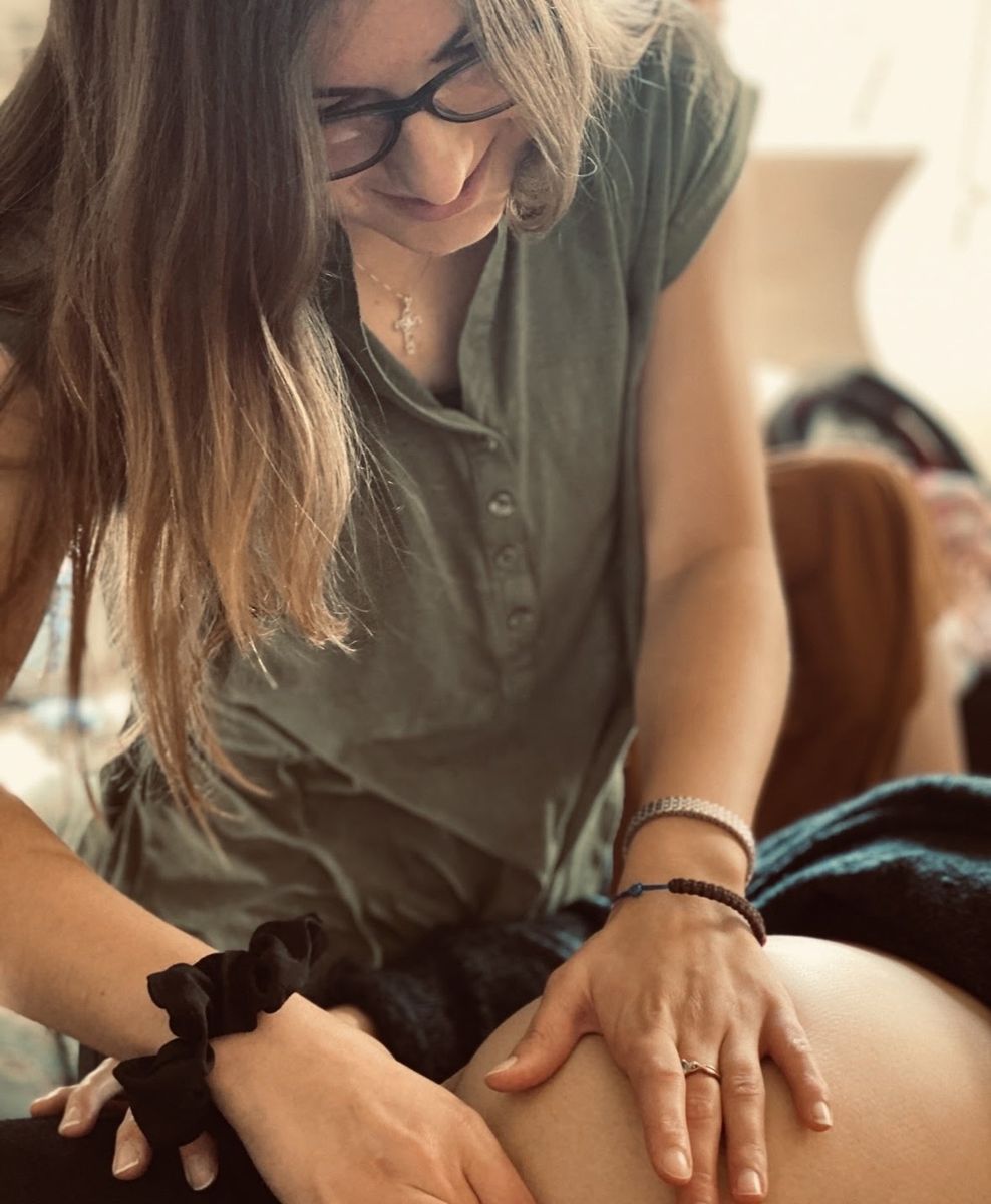 Taylor gently checks a pregnant mother's belly during a prenatal visit in Louisville